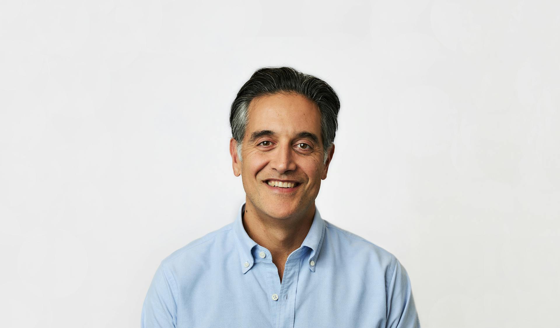 Image of Dr. B CEO, Cyrus Massoumi, smiling in a blue shirt